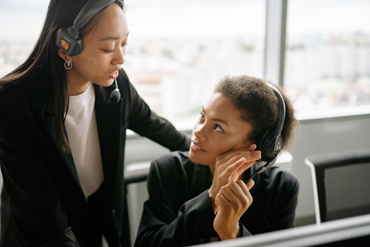 Two women wearing headsets having a conversation