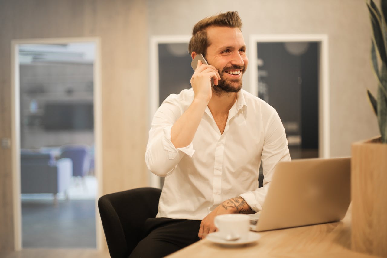 A smiling businessman talking on the phone