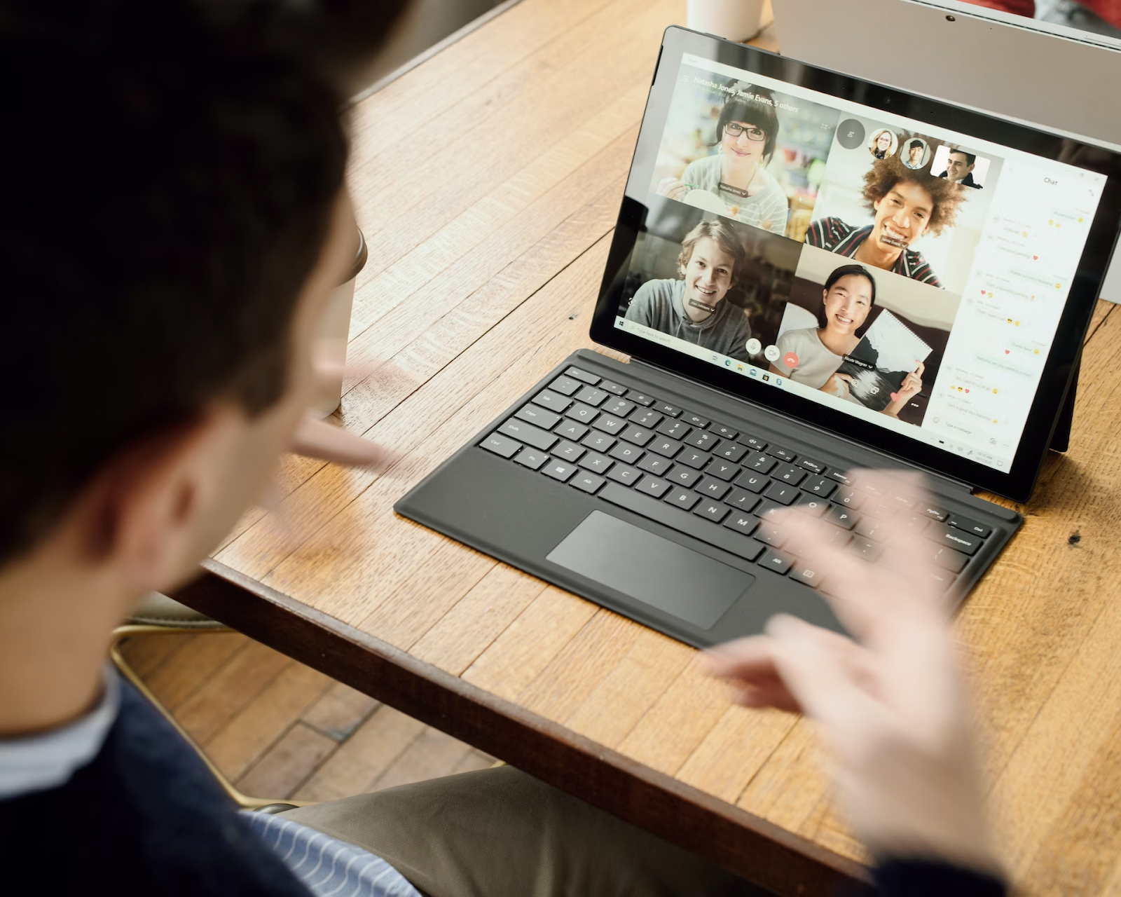Man on computer in a video conference.