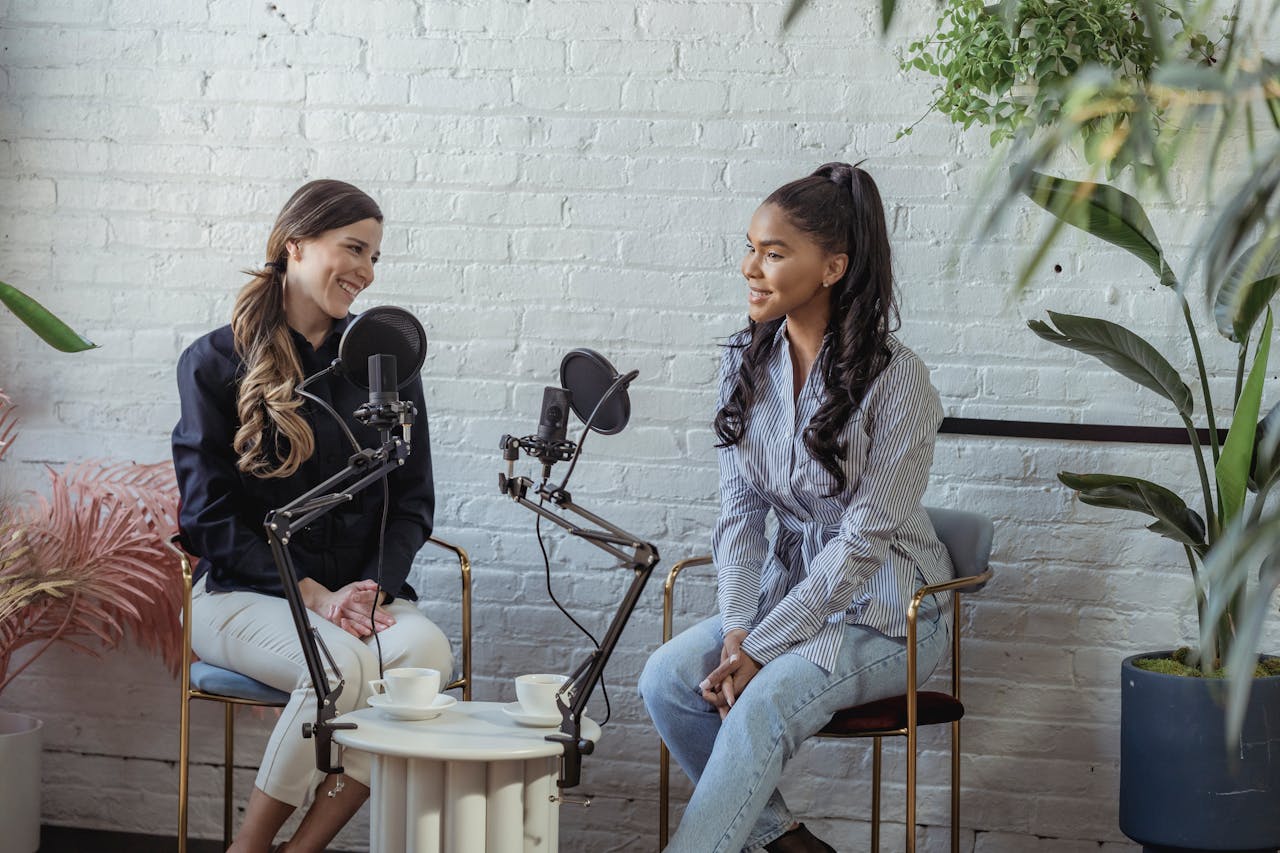 Two women talking into microphones